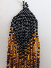 Load image into Gallery viewer, Beaded earring with black, brown, and gold beads on a white background