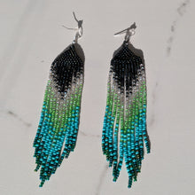 Load image into Gallery viewer, Long beaded fringe earrings with a black, white, green, and turquoise gradient design
